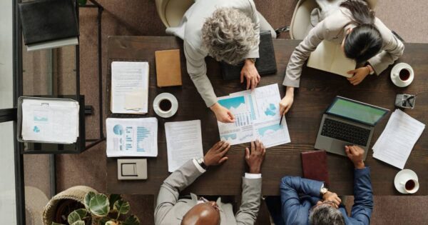 People at a desk in a business planning meeting