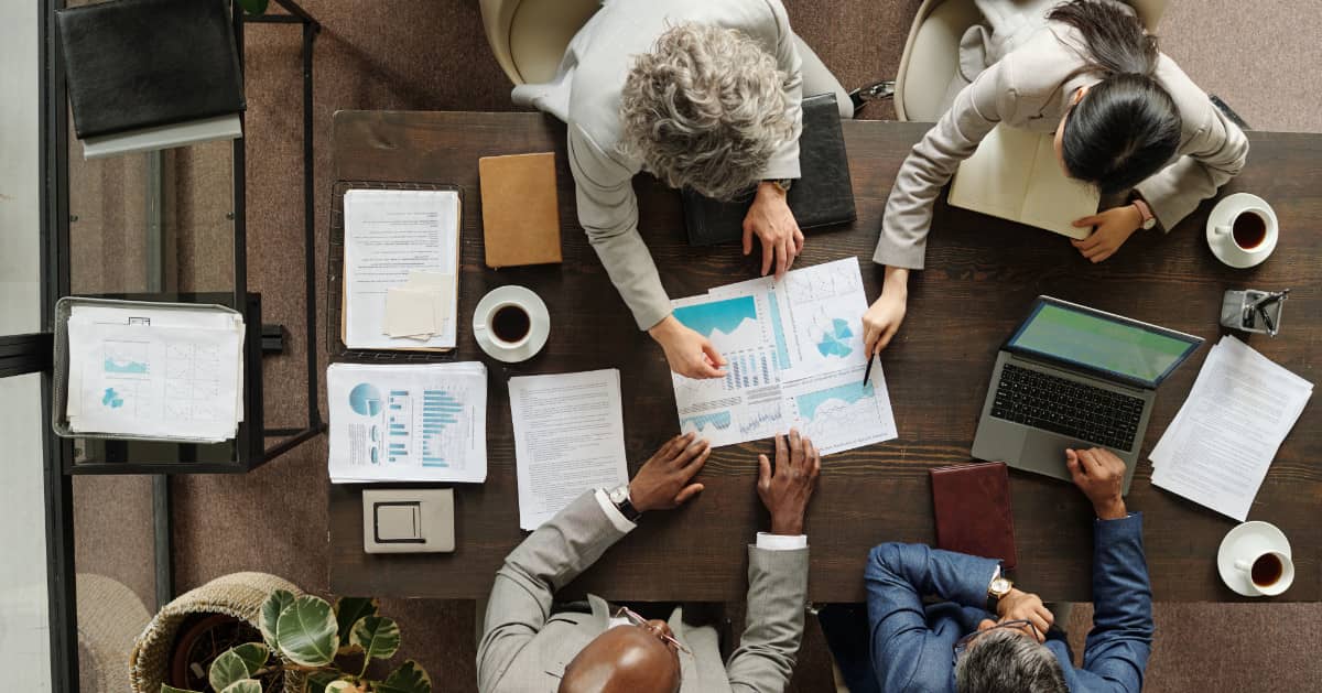 People at a desk in a business planning meeting